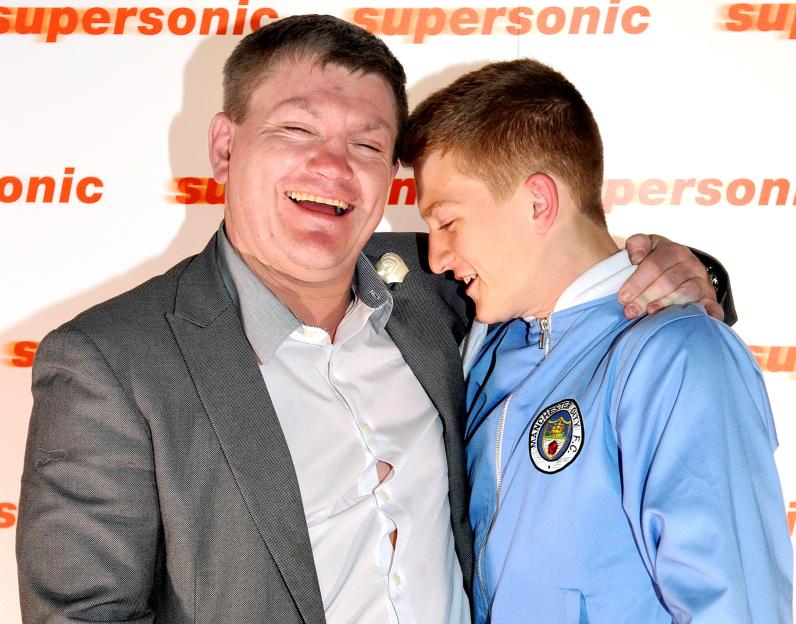 Boxer Ricky Hatton and his son Campbell Hatton laugh together at a red carpet event.