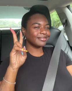 Woman in a car showing peace sign, text overlay reads