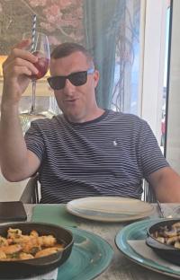 Man holding a drink in a restaurant.
