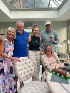 Family celebrating a birthday with a caterpillar cake.