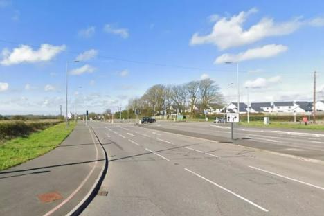 Road intersection with traffic lights and a pedestrian crossing.
