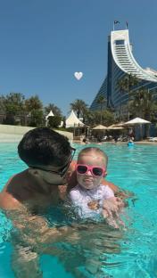 Man and toddler in a pool.