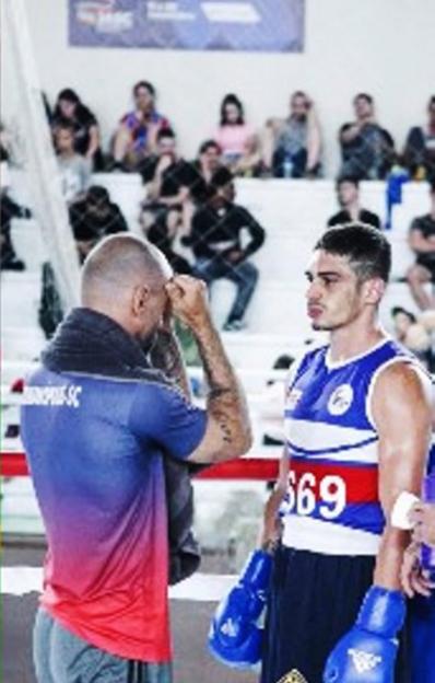 Flavio Augusto Schuller Azambuja with a coach at a boxing match.
