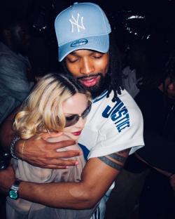 Madonna embraced by a man at a party.