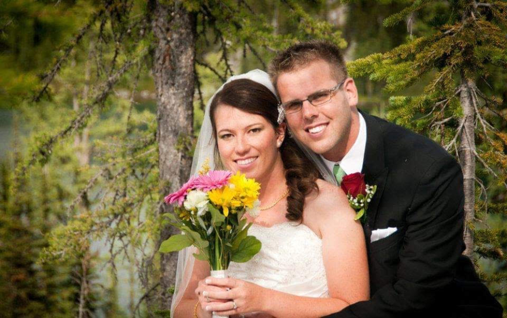 Bride and groom posing for a wedding photo.