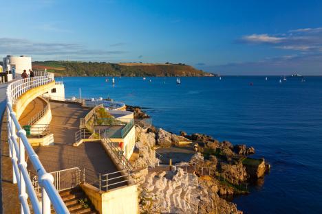 Outdoor swimming pool and walkway overlooking the sea.