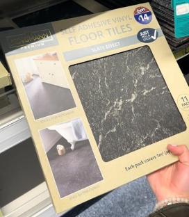 Box of Kingmann Premium self-adhesive vinyl floor tiles with slate effect.