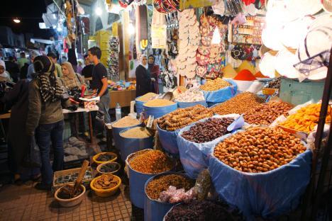 Market in Medina, Rabat, Morocco, with various spices and dried fruits on display.