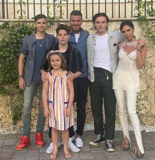 The Beckham family posing for a photo.