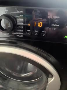 Washing machine control panel showing a hidden cleaning code.