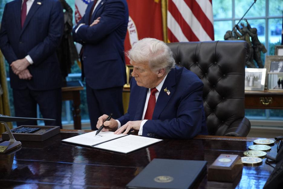 US President Donald Trump signs executive orders in the Oval Office at the White House.