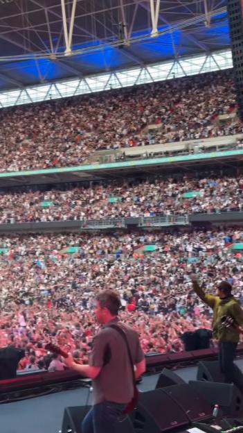 Thousands of Oasis fans at a sold-out Wembley Stadium concert.