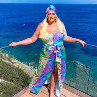 Gemma Collins in a colorful swimsuit and headscarf.