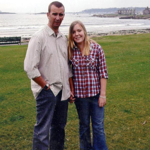 Photo of a man and a teenage girl holding hands.