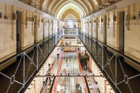 Interior view of Reading Prison, showing prison cells and visitors on walkways.