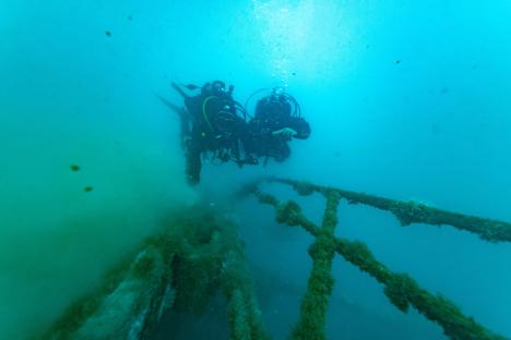 Two divers exploring the wreckage of the sunken Bayesian yacht at a depth of 49 meters.