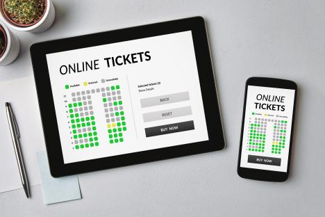 Tablet and smartphone showing online ticket purchase interface.