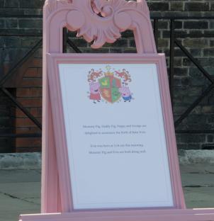 Pink easel announcing the birth of Baby Evie to the Peppa Pig family.