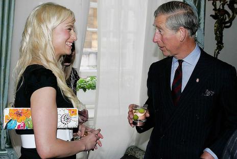 Prince Charles speaking with a woman at a reception.