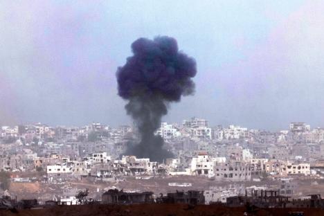 Smoke billowing over destroyed buildings in Gaza.