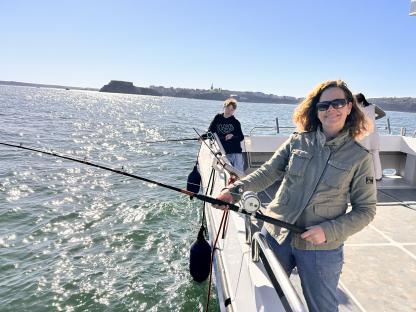 Woman fishing on a boat.