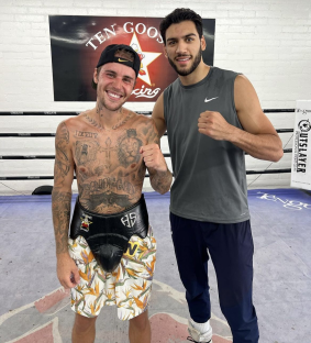 Two boxers in a gym.