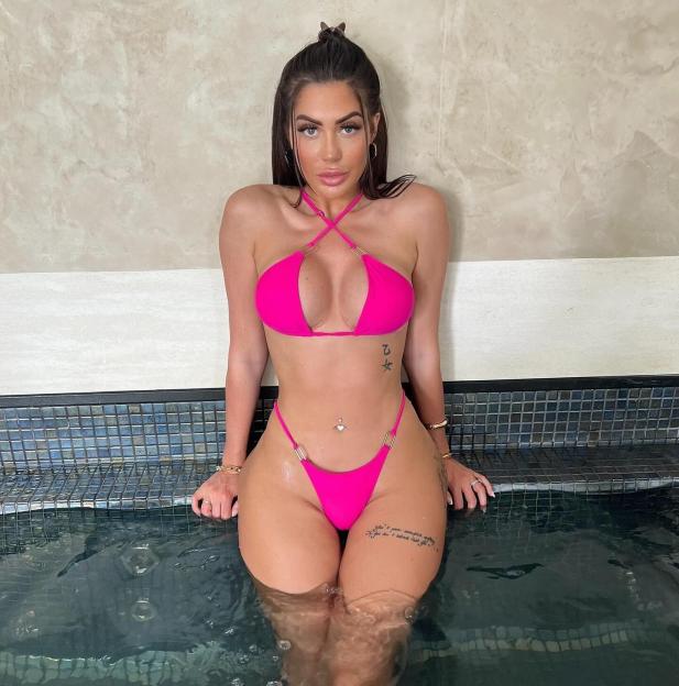 Chloe Ferry in a pink bikini in a hot tub.