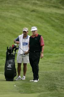 Jay Sigel on a golf course with his caddy.