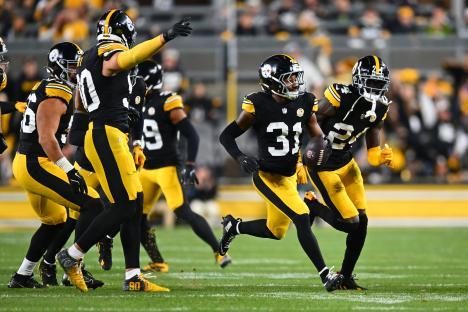 Pittsburgh Steelers player #31 running with the football after an interception.
