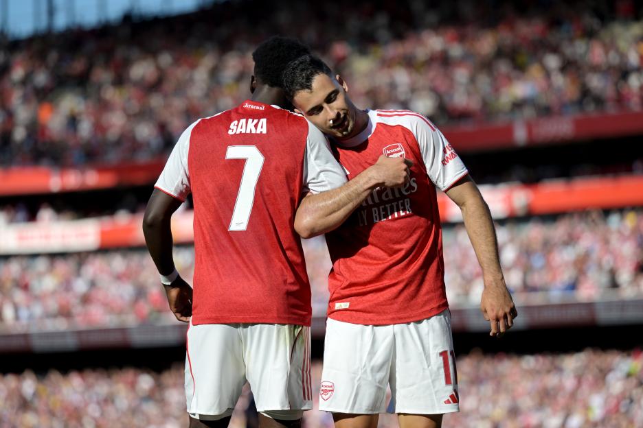 Arsenal's Saka and Martinelli celebrating a goal.