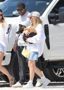 Sydney Sweeney and Jonathan Davino with a German Shepherd puppy.