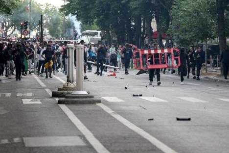 Chaos erupts in Paris as riot cops clash with PSG fans at Champions League victory parade in second night of violence