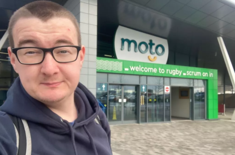 Rich James Cross in front of a Moto service station.