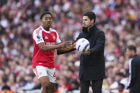 Myles Lewis-Skelly and Mikel Arteta at an Arsenal soccer match.