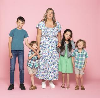 Mother and her four children posing together.