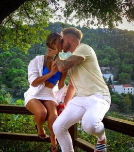 Couple kissing on a scenic overlook.