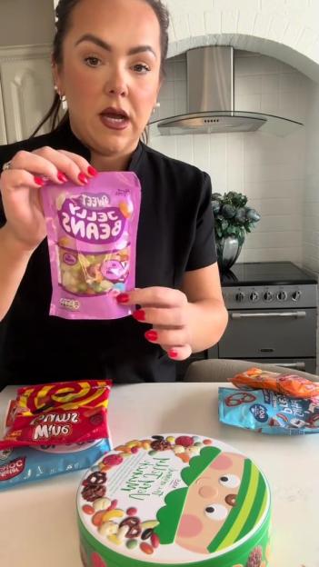 A woman holding a bag of "Sweet Jelly Beans" in a kitchen.