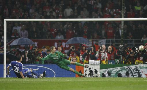 John Terry of Chelsea kicks a penalty wide, as Edwin van der Sar of Manchester United dives.