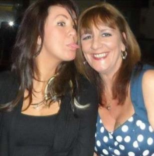 Photo of two women, one sticking her tongue out.