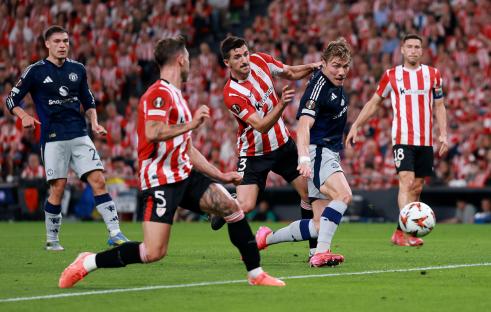 Rasmus Hojlund of Manchester United pulled down by an Athletic Bilbao player.