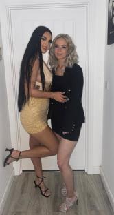 Two sisters posing for a photo.