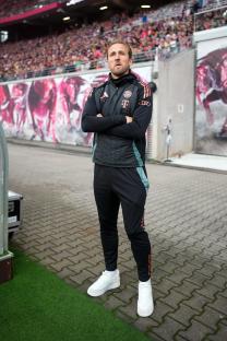 Harry Kane of Bayern Munich standing with arms crossed.