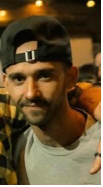 Photo of a man in a baseball cap, wanted for questioning in connection with a sexual assault.