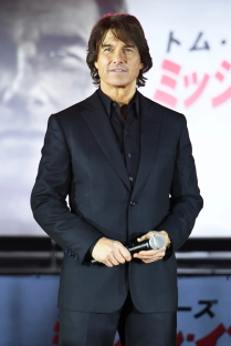 Tom Cruise holding a microphone.