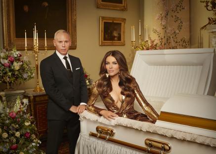 Rob Rinder and Elizabeth Hurley posing with a coffin.