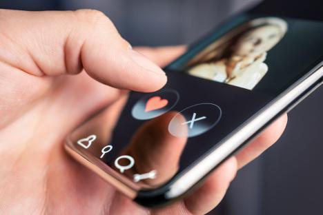 Person using dating app on phone.