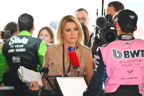 A reporter interviews a Formula 1 driver.