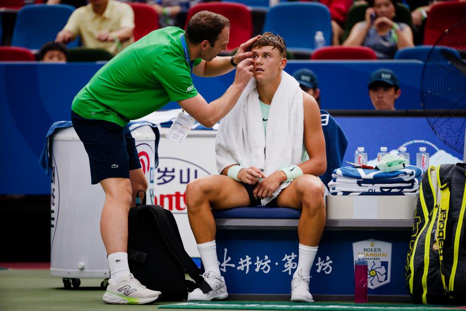 Holger Rune receives medical attention at the Shanghai Masters tennis tournament.