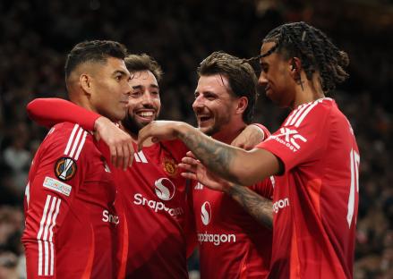 Manchester United players celebrating a goal.