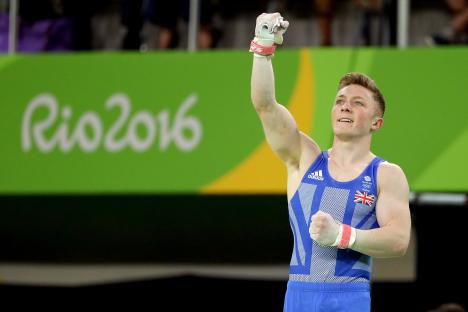 Nile Wilson of Great Britain celebrating after a horizontal bar gymnastics competition.